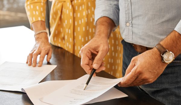 Theres a lot of paperwork. Shot of two unrecognizable people going through paperwork